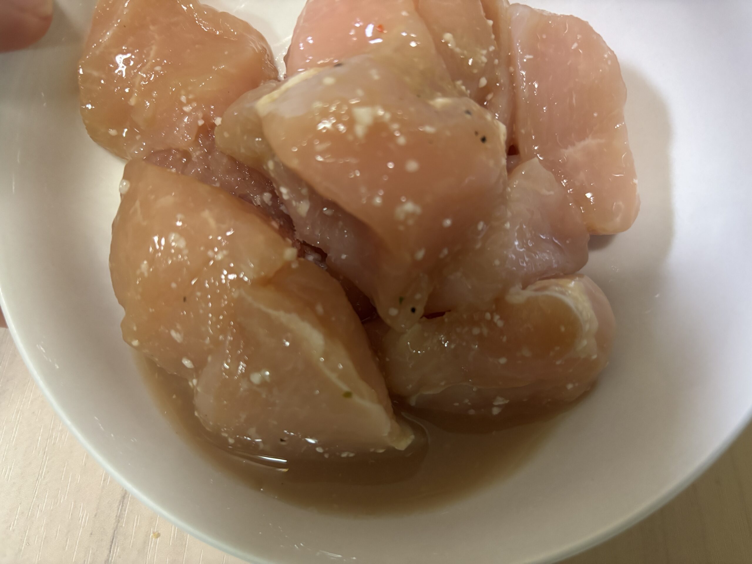 冷蔵庫で12時間解凍した鶏むね肉。皿の底に肉汁が溜まっている